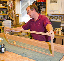 Man making a frame for boat construction.
