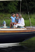 Family on the stern of a cruising yacht, Rhode Island.