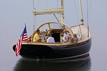 Young family at anchor aboard a Friendship 40 cruising yacht, Rhode Island. Model and property released.