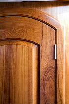 Door / cupboard detail in the interior of a classic cruising yacht, USA.