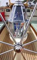 Wheel and compass detail aboard a cruising yacht. Rhode Island, USA.