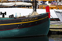 Old wooden classic "Lewis H. Story" moored to pontoon at the Newport Wooden Boat Show, Rhode Island.