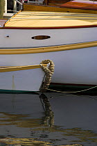 Tender moored with hand-made rope bow fender at the Newport Wooden Boat Show, Rhode Island.