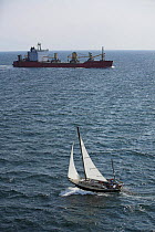 Classic yawl beating upwind towards a ship in Narragansett Bay, Rhode Island.