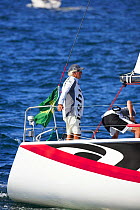 Man standing on the stern of a yacht during racing at the Farr 40 one-design class World Championship.
