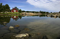 A wooden holiday cottage beside the shore, Borsto, Finnish Archipelago, Finland.