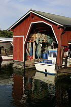 Wooden boathouse with boat inside, Gullkrona, Finnish Archipelago, Finland.