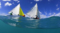 Split-level view of colourful local boats racing at Grenada Sailing Festival, Caribbean, 2006.