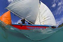 Split-level view of colourful local boat rounding the mark during a race at Grenada Sailing Festival, Caribbean, 2006.
