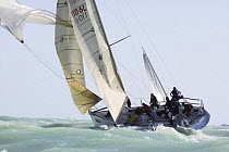 Spinnaker drop on a one-design class yacht, Key West Race Week 2006, Florida, USA.