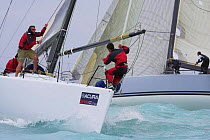 One-design class crew preparing the spinnaker pole, Key West Race Week 2006, Florida, USA.