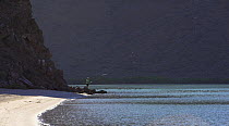 A man fly fishing at the end of a deserted beach in El Cardonal, Isla La Partida, Mexico. 2006.