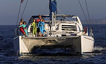 A family on the stern of their catamaran after a vacation cruising in Baja Mexico. 2006.
