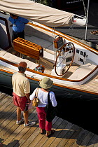 People looking at a docked sailboat during the annual Newport Boat Show, Rhode Island, USA. September 2006.