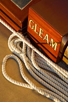 Rope and name detail on board 12m yacht "Gleam" sailing off Newport, Rhode Island, USA, 2006.