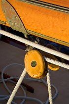 Wooden block and rigging detail on board 12m yacht "Gleam" sailing off Newport, Rhode Island, USA, 2006.