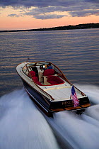 Hinckley T38R speedboat travelling fast at sunset, Rhode Island, USA.