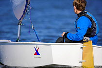 Young boy sailing Vanguard Optimist dinghy, Charleston, South Carolina, USA.
