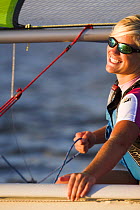Smiling girl Vanguard RS dinghy sailing, Charleston, South Carolina, USA.