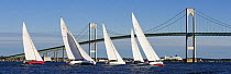 A fleet of 12m yachts racing in front of the Newport Bridge, Rhode Island, USA. October 2006.