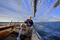 Helmsman on board Weatherly a 12m yacht in Narragansett Bay, Newport, Rhode Island, USA. October 2006