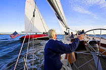 Racing onboard 12m Weatherly with American Eagle to leeward in Narragansett Bay, Newport, Rhode Island, USA. October 2006. Model (helmsman) and Property Released (both boats).