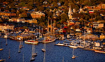 View during October 2006 of boats anchored in Newport Harbor, Rhode Island, USA. Trinity Church and downtown Newport in the background.