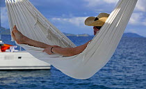 Woman lying in a hammock, British Virgin Islands, Caribbean, December, 2006.