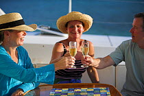 Sundowner drinks aboard a yacht, British Virgin Islands, Caribbean. December 2006.