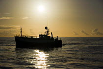 Commercial fishing trawler fishing on the North Sea in perfect weather. July 2007.