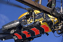 Winchman preparing to be lowered from a helicopter during a training excercise on the North Sea.