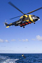 Winchman being lowered from a helicopter during a training excercise on the North Sea.