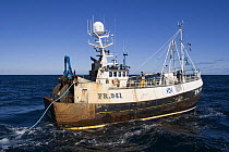 Fishing vessel paying out trawl warp at the start of a fishing operation in the North Sea. July 2007.