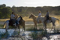 Horse riders at La Caldara (a sulphurous hot water valley), Manziana, Lazio, Italy.