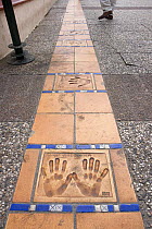 Hand prints of famous actors and movie directors on the Croisette in front of the Cinema Festival Palace, Cannes, France.