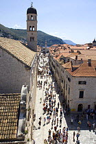 Crowds of people walking up a street in the town of Dubrovnik, Croatia.