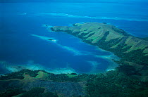 Aerial view of Coral Reefs and deforested hills along the coast of Fiji.