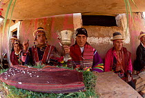 Quechua men with silver cup at traditional wedding ceremony Bolivia