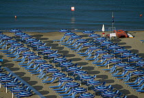 Beach umbellas and sunloungers on beach Castiglione della Pescaia Italy. 1995.