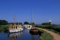 Boats on Norfolk Broads with windmill, Horsey, Norfolk, UK