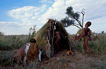 San bushman family by huts Kalahari Botswana Southern Africa