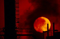 Belching smokestacks at sunset industry related pollution Avonmouth Docks Bristol UK