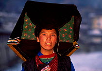 Black Yi married woman wears traditional dark colours Lijiang county, Yunnan, China ethnic