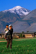 Bai woman carrying child ethnic minority group Erhai lake, Dali, Yunnan, China
