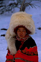 Nosi Yi woman in White fox hat (not traditional Red Panda fur) Lijiang Yunnan China