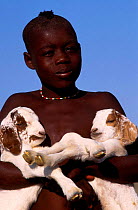 Himba boy with young goats Kaokoland Namibia