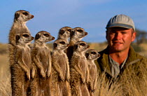Simon King with meerkat family {Suricata suricatta} film maker on Meerkats: Part of a Team