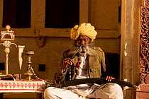 Old warrior smoking pipe outside Meherangash fort Jodhpur Rajasthan India