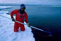 Andrew Taqtu Inuit field assistant with remote camera Canadian arctic Lancaster sound