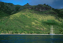 Coastal view of Yasawa Group island with boat moored near shore Fiji South Pacific